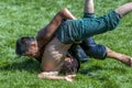 A young wrestler is overpowered by his opponent at the Elmali Turkish Oil Wrestling Festival in Elmali in Turkey. Royalty Free Stock Photo