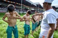 Young wrestlers have olive oil poured onto their bodies prior to competition beginning at the Kirkpinar Turkish Oil Wrestling Fest