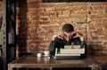 Young writer with a classic typewriter. he`s going to work