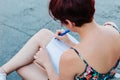 Young writer girl with pencil writing in notebook or personal diary outdoors looking for inspiration to write a book Royalty Free Stock Photo