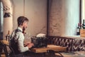 Young writer typing on a typewriter