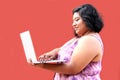 20 year old overweight brunette Latina woman uses her laptop to study, do homework, date, shop online and chat with her friends