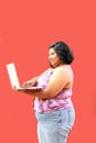 20 year old overweight brunette Latina woman uses her laptop to study, do homework, date, shop online and chat with her friends