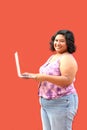 20 year old overweight brunette Latina woman uses her laptop to study, do homework, date, shop online and chat with her friends