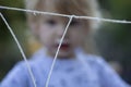 Young, 4 year old preschool boy with a grey shirt and blond hair, blowing bubbles in the yard Royalty Free Stock Photo