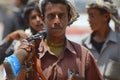 Young Yemeni man holds a rifle in Aden, Yemen.