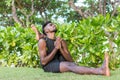 Young yoga man practitioners doing yoga on nature. Asian indian yogis man on the grass in the park. Bali island. Royalty Free Stock Photo