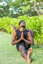 Young yoga man practitioners doing yoga on nature. Asian indian yogis man on the grass in the park. Bali island. Royalty Free Stock Photo