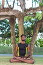 Young yoga man practitioners doing yoga on nature. Asian indian yogis man on the grass in the park. Bali island. Royalty Free Stock Photo