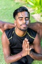 Young yoga man practitioners doing yoga on nature. Asian indian yogis man on the grass in the park. Bali island. Royalty Free Stock Photo