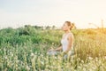 Young yoga woman practicing yoga on the meadows sunset. Royalty Free Stock Photo