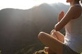 Young yoga woman at sunrise mountain