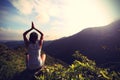 Young yoga woman at sunrise mountain