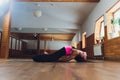 Young yogi attractive woman practicing yoga concept, standing in salamba sirsasana exercise, headstand pose, working out Royalty Free Stock Photo