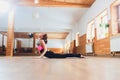 Young yogi attractive woman practicing yoga concept, stretching in Cobra exercise, Bhujangasana pose, working out Royalty Free Stock Photo