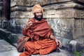 Young yogi sits near the temple of Krishna.