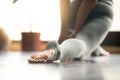 Young yogi woman in anjaneyasana pose, home background, close up Royalty Free Stock Photo