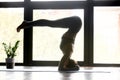 Young yogi woman doing yoga headstand exercise Royalty Free Stock Photo