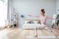 Young yogi woman practicing yoga pose, working out home