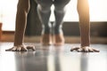 Young yogi woman standing in Plank pose, home interior backgroun