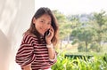 younger asian woman talking on smart phone with happiness emtion