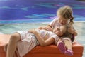 Younger sister cradling older. Royalty Free Stock Photo