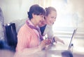 Younger woman helping an elderly person using laptop Royalty Free Stock Photo