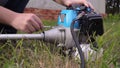 Young man assembling parts of the string trimmer. Royalty Free Stock Photo