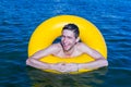 Youngman on a inflatable buoy laughing