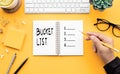 Youngman writing bucket list on notepad Royalty Free Stock Photo