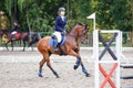 Young girl riding sorrel horse on show jumping Royalty Free Stock Photo