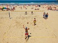 Youngs mens playing volleyball in Zurriola beach, San Sebastian. Spain.