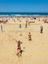 Youngs mens playing volleyball in Zurriola beach, San Sebastian. Spain.