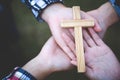 Youngs praying womans hands with wooden cross and Holy Bible. Religion concept Royalty Free Stock Photo