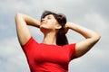 Young girl smiling, cloudy sky Royalty Free Stock Photo