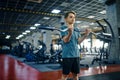 Youngster doing exercise with bar in gym