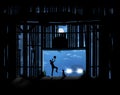 A youngster shines his carÃ¢â¬â¢s headlights on the old barn where he is practicing basketball in the moonlight. Royalty Free Stock Photo