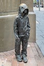 Youngsters - child sized bronze statue of young urchin boy wearing a hoodie in George Street, Sydney, Australia