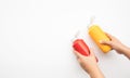 Youngwoman squeezing bottles sauce  mustard,ketchup for dipping on white background Royalty Free Stock Photo