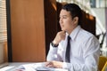 Younng handsome Asian man sitting by the window Royalty Free Stock Photo