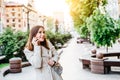 Younng woman talking phone at city street. Petty businesswoman speaking mobile. Business lady call phone. Pleasant Royalty Free Stock Photo