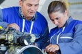 Youong female apprentice mechanical engine Royalty Free Stock Photo