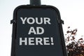 your ad here advertisement vertical rectangle sign on post outdoor, white text. p Royalty Free Stock Photo