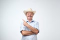 Your advertising here. Studio portrait of handsome senior man in blue shirt and cowboy hat showing copy space Royalty Free Stock Photo