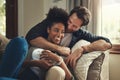 In your arms I found my heaven. a happy young couple relaxing on a couch in their living room at home. Royalty Free Stock Photo