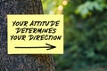 Your attitude determines your direction message written on paper on a tree. Inspirational or motivational quote