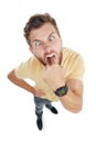 Your attitude makes me sick. Studio portrait of an angry young man sticking his finger down his throat against a white