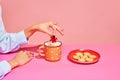 Your bets. Food pop art photography. Young girl tasting milk with crackers over pink background. Concept of