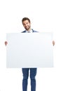 Your brand endorsed with corporate charm. Studio shot of a handsome businessman holding up a blank placard against a