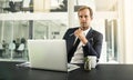 Is your company keeping up with the evolution of technology. Portrait of a businessman sitting in an office with his Royalty Free Stock Photo